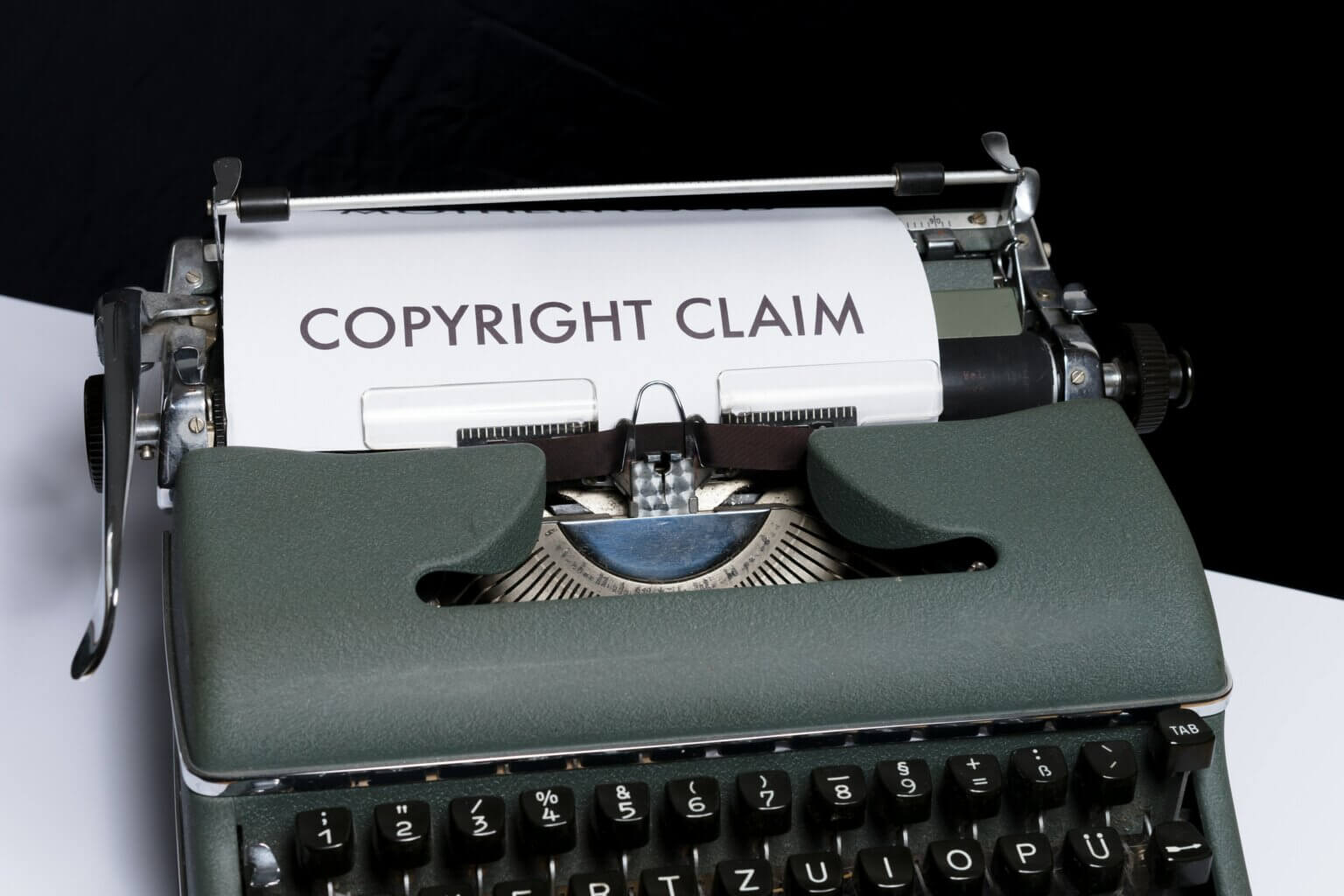 Photo of an old typewriter, displaying the words, "Copyright Claim."