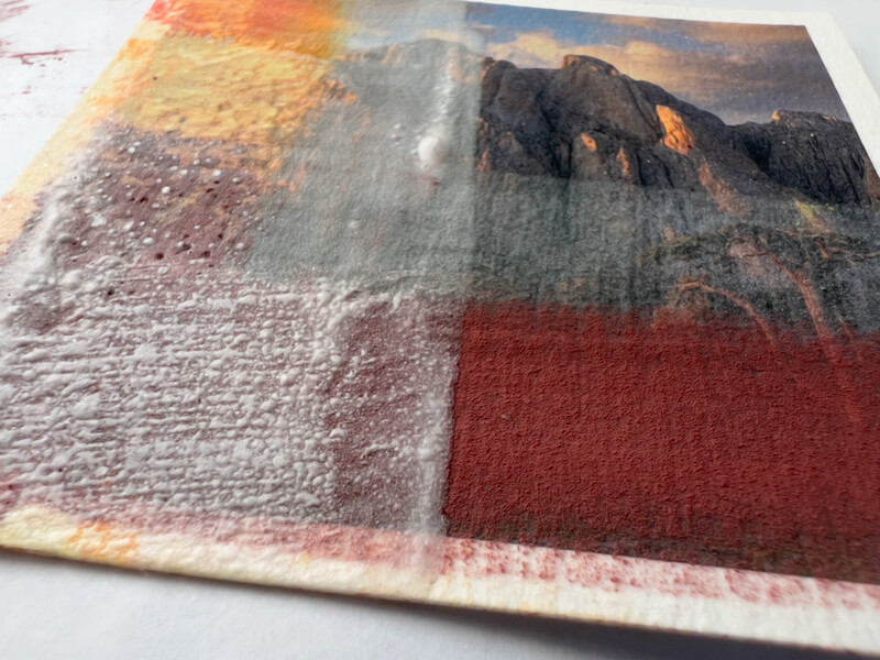 Experimenting with painting on photos: Layered, texturized thin gesso on a test photo print.