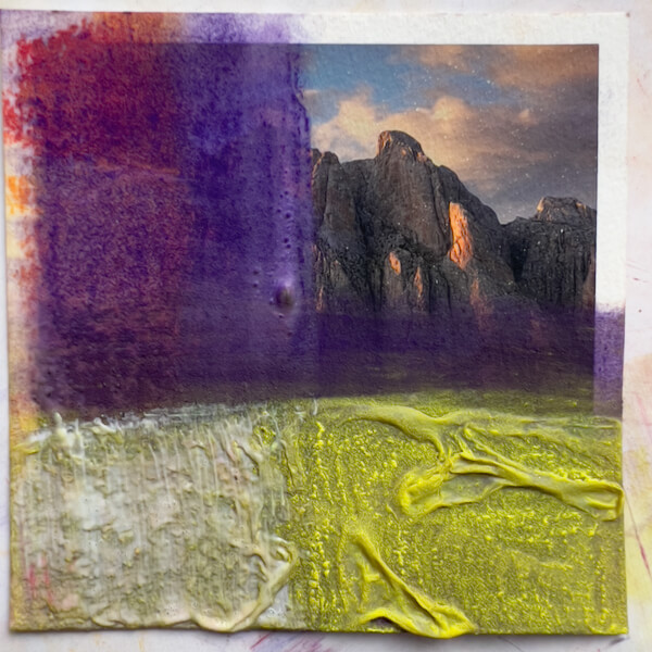 Textured, swirled, thick gesso over a photo print, pastels applied over bubbles, more gesso applied.